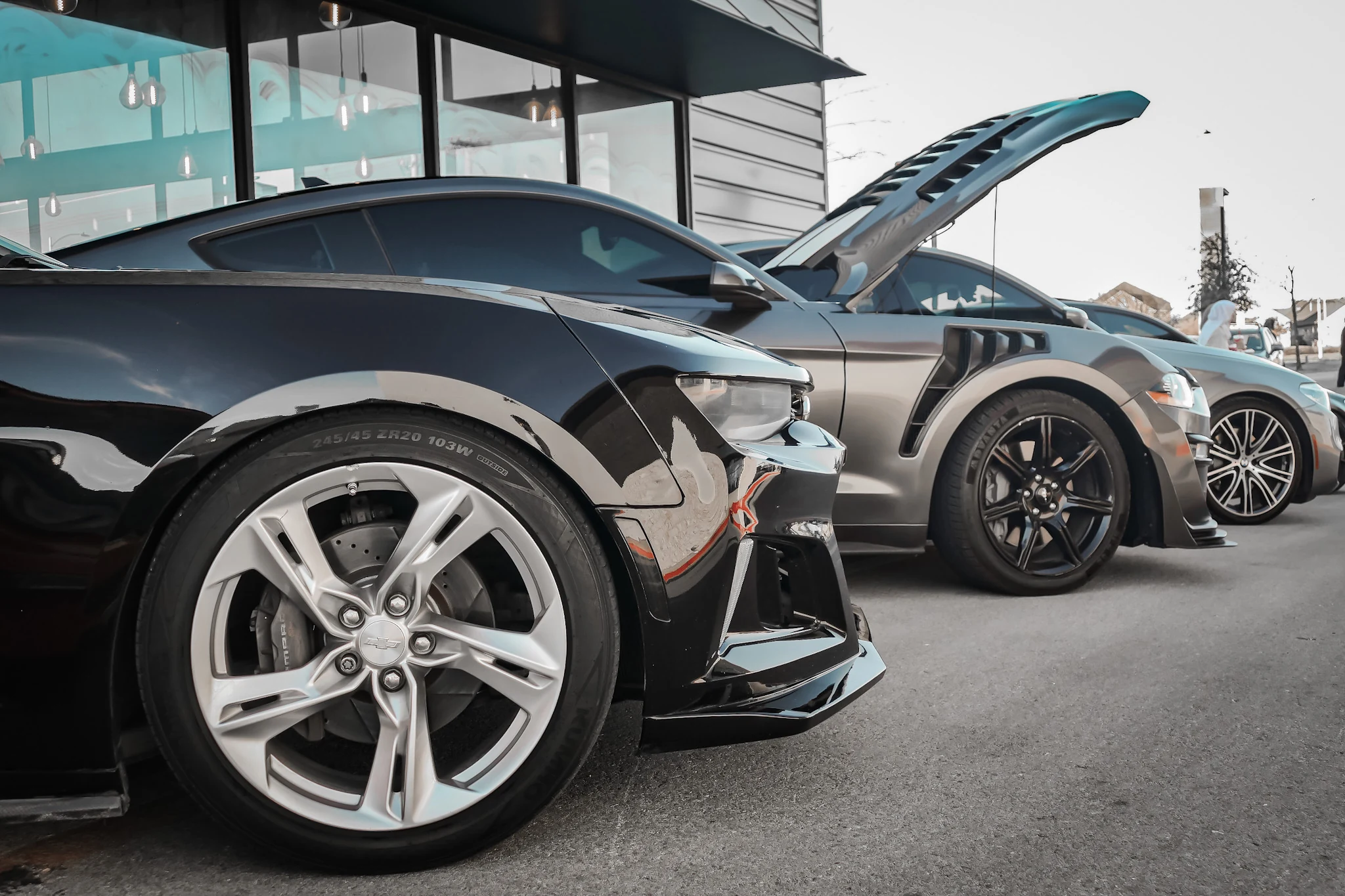 Performance cars lined up outside an automotive gathering