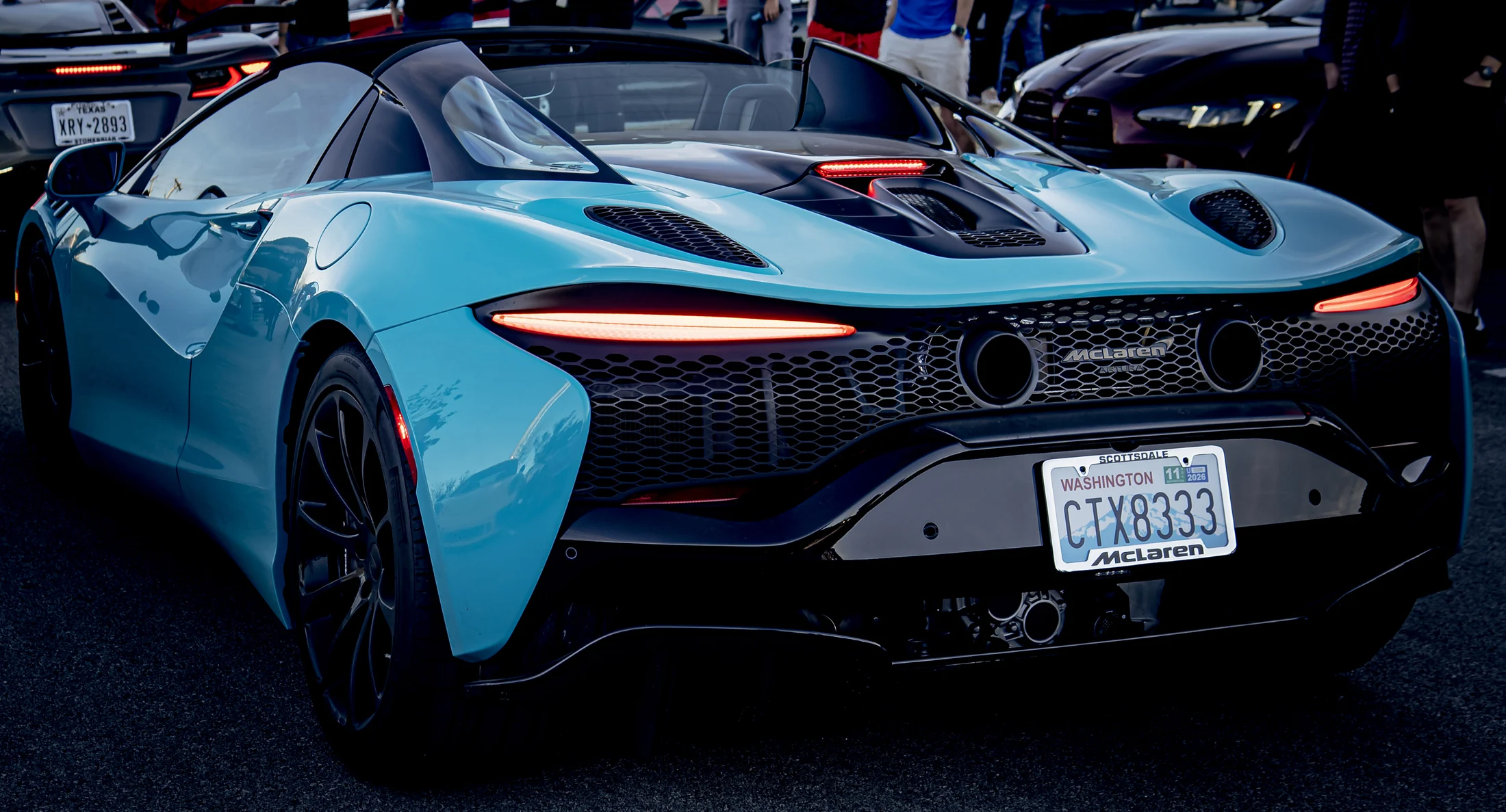 Turquoise McLaren photographed from the rear